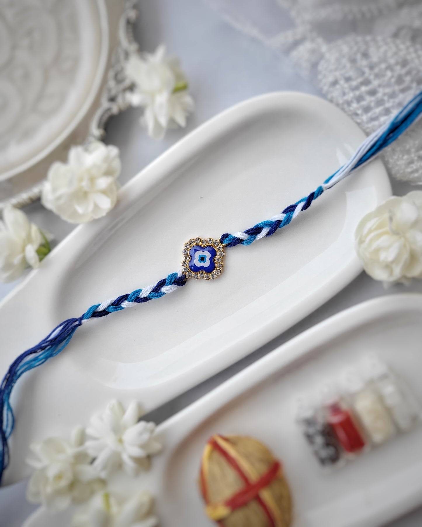 Stone Studded Evil Eye Four Petal Rakhi