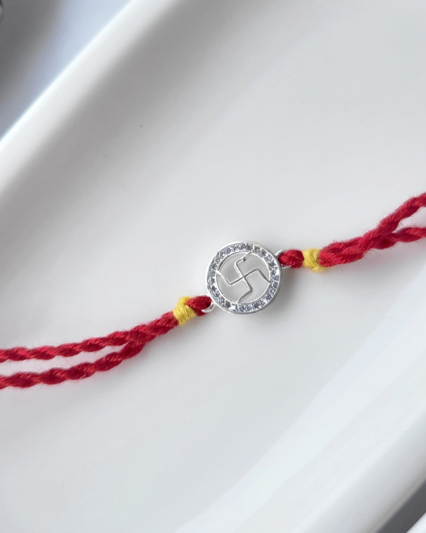 Swastik Silver Rakhi with Studded Stones